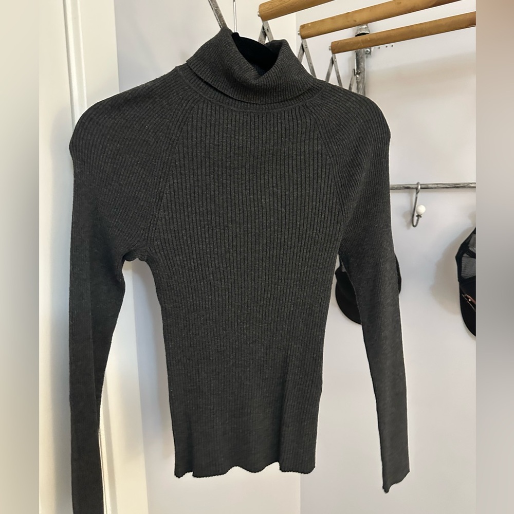 Dark charcoal gray ribbed turtleneck. Light weight sweater.